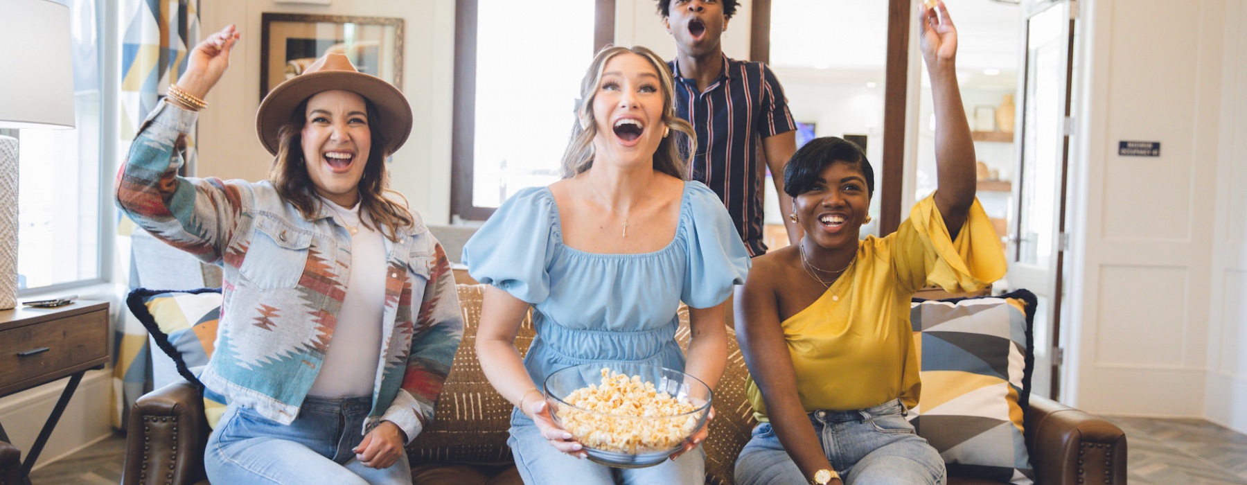 Friends eating popcorn watching tv