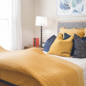 Generous bedroom offerings to fit every family a man making a bed